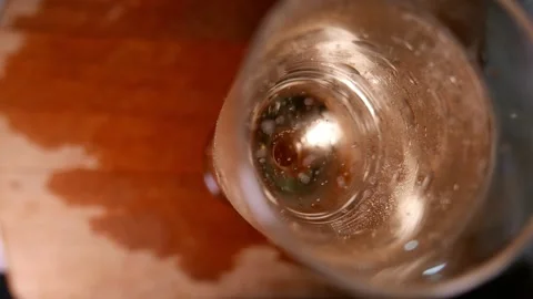 Sparkling wine bubbles rising in a flute glass (top view). POV: champagne glass Video stock 345008864