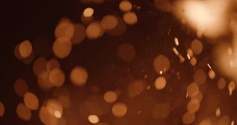 Sparks and embers float up out of focus with flame in foreground Stock Footage 102788877