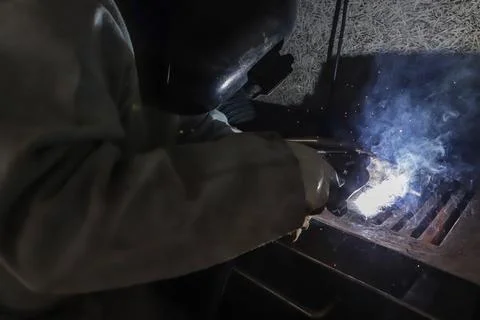 Sparks and light from work. In the image, it is possible to see the worker's Stock Photos
