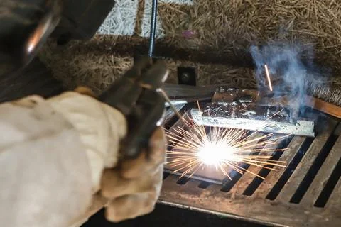 Sparks and light from work. In the image, it is possible to see the worker's Stock Photos