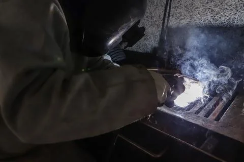 Sparks and light from work. In the image, it is possible to see the worker's Stock Photos