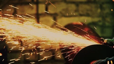 Sparks from the angle grinder fly in different directions Stock Footage 112432205