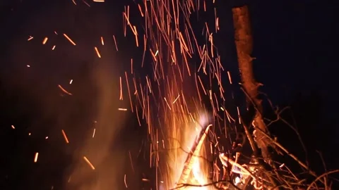 Sparks of a bonfire scattering in the night Stock Footage 160739846