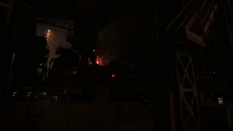 Sparks bursting out while iron melting, distant view Stock Footage 72761982