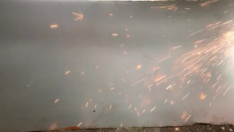 Sparks can be seen during the process of cutting iron plates using a grinder 스톡 동영상 324612406