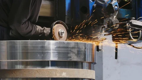 Sparks during the cutting of metal by an angle grinder. The worker cuts off t Stock-Footage 118976443