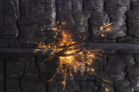 Sparks explosion between electrical cables, on burned wood texture backgrou.. Stock Photos