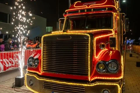 Sparks flash in front of a Coca-Cola truck, creating a festive atmosphere Stock Photos