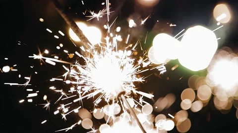 Sparks fly in different directions from burning sparklers. Close-up shooting Stock Footage 237766160