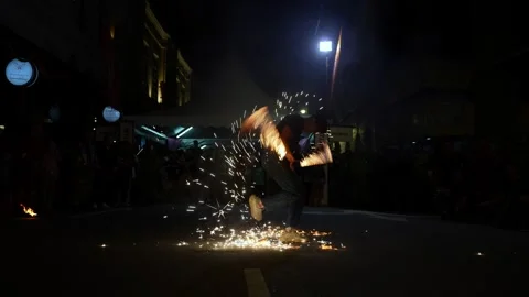 Sparks fly during an intense fire flame ritual. Stock Footage 318090582