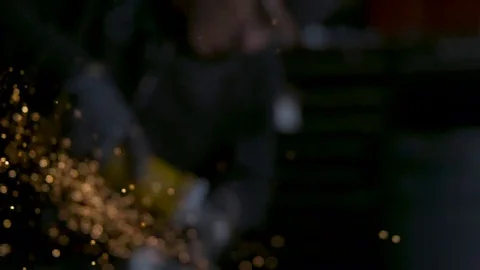 Sparks fly as from grinder in industrial setting. slow motion. Stock Footage 69218068