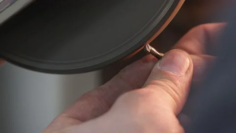 Sparks fly as Masterful Engineer grinds tiny metal piece with precision, danger Stock Footage 136800160