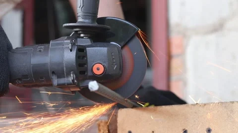 Sparks fly when cutting rebar with a grinder, construction work close-up Video stock 331255804