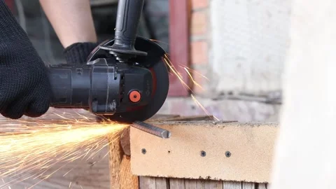 Sparks fly when cutting rebar with a grinder, construction work close-up Stock Footage 331255818
