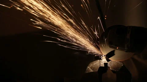 Sparks fly while the man cutting a metal rod with a grinding machine Stock Footage 59596132