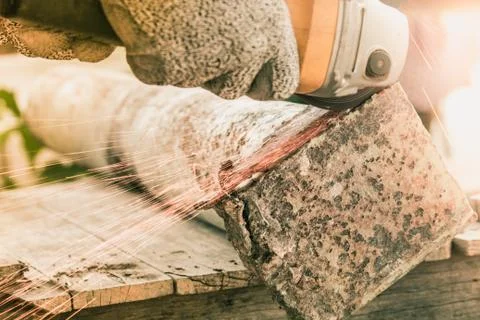 Sparks flying over the working during metal grinding Stock Photos