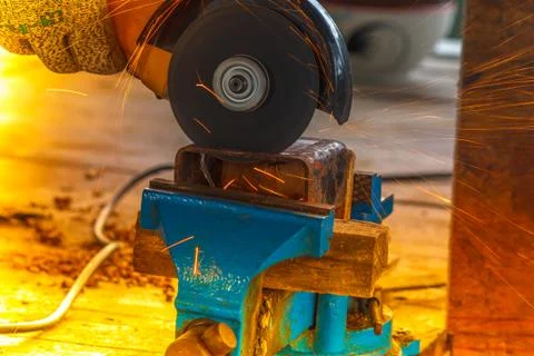 Sparks flying over the working during metal grinding Stock Photos