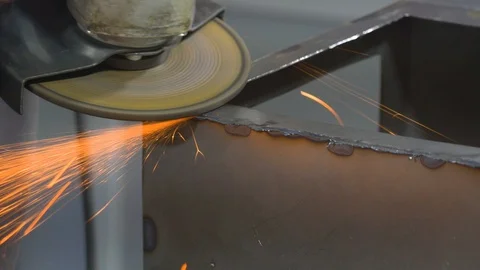 Sparks flying over the working table during metal grinding. Stock Footage 111330999