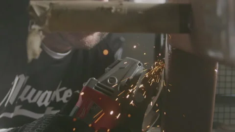 Sparks Flying Toward Camera as Man Grinds Metal Vidéo 137247562