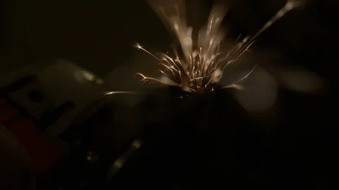 Sparks flying towards the camera while grinding steel Stock Footage 100126945