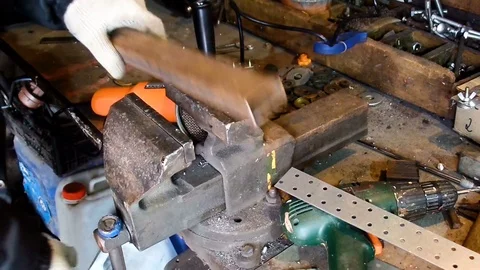 Sparks frying on the black background during metal grinding in his workshop Stock Footage 71484577
