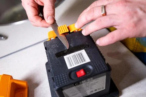 Sparks grinding wheel while knife sharpening. Man sharpens knives on a grinder Stock Photos
