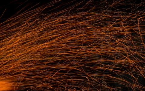 Sparks of an open campfire scattering when a gust of wind Stock Photos