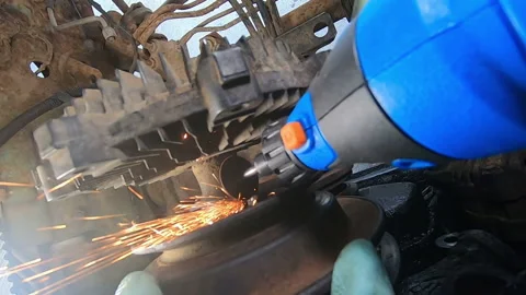 Sparks from a screw being cut by a mini drill on an engine, audio Stock Footage 171085091
