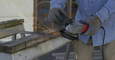 Sparks showering across workshop from angle grinder metal in slow motion 4K Stock Footage 80426578