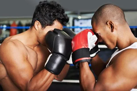 Sparring face to face. two young boxers sparring in a ring. Fotos de archivo