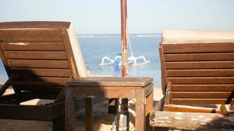 Sparrows flying around sunbeds Stock Footage 156430853