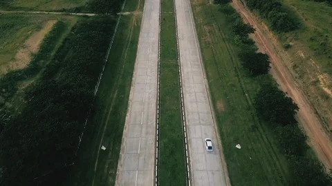 Sparse cars drive down long Myanmar highways at day Video stock 95673776