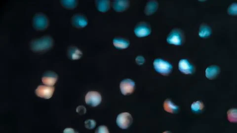 Sparse Cyan Bokeh Dots on Black Background, Abstract Defocused Light Partic.. Фото