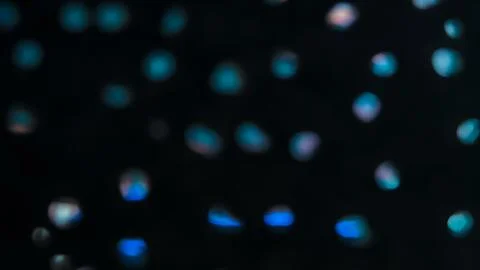 Sparse Cyan Bokeh Dots on Black Background, Abstract Defocused Light Partic.. Фото