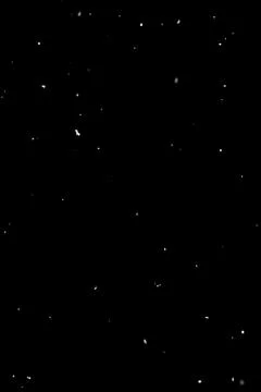 Sparse falling snow on black background, isolated overlay effect for editing Stock Photos