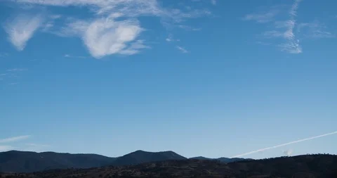 Sparse Wispy Clouds Blue Sky Timelapse Over Mountains 4K Stock Footage 113934230