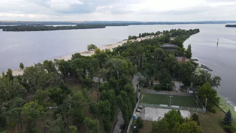 A sparsely populated white sand beach surrounded by trees and clear waters of Stock Footage 194012986