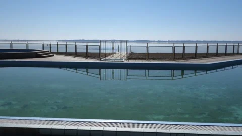 Spatial view of the summer outdoor pool and its surroundings by the big lake Stock Footage 172384031