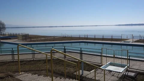 Spatial view of the summer outdoor pool and its surroundings by the big lake Stock Footage 172384180