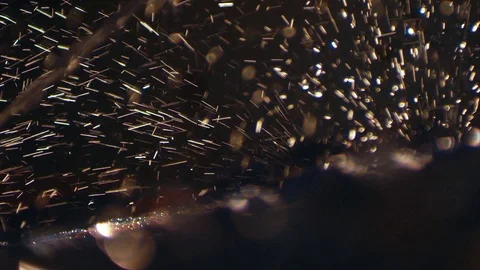 Spatters and streams of water fall in dark studio, closeup Stock Footage 74438060
