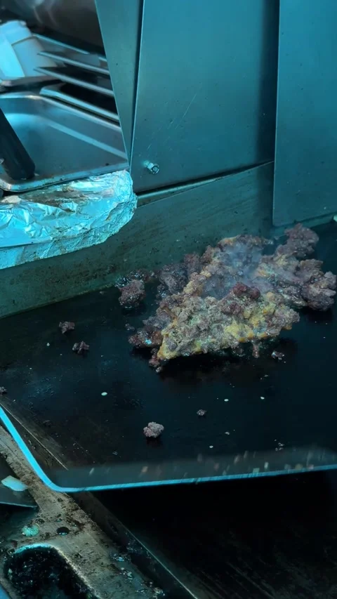 Spatula Flips Chorizo on Flat Top Grill Stock Footage 313357959