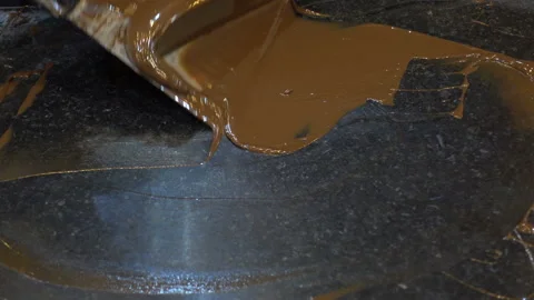 The spatula picks up the melted chocolate. Video stock 212451789