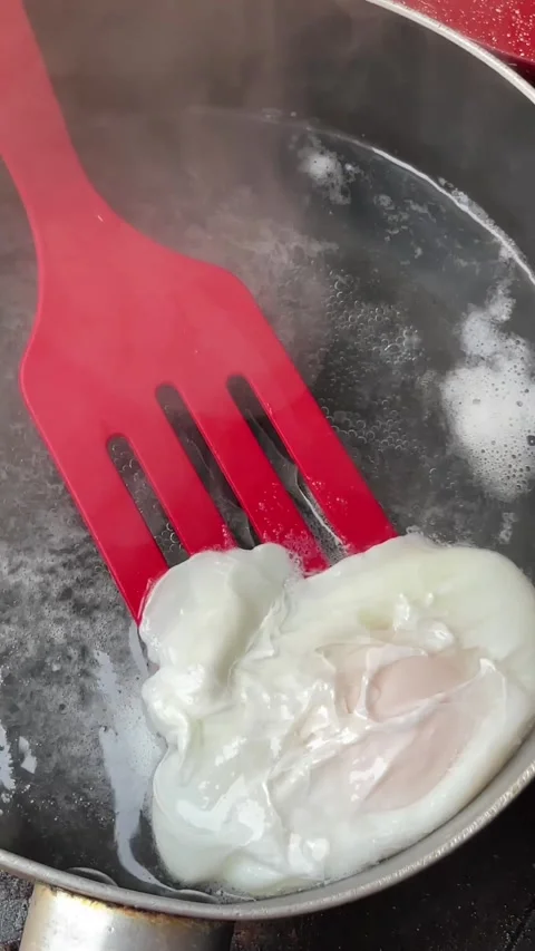 Spatula removing poached egg. Stock Footage 287860224