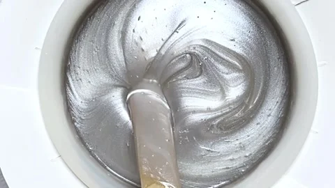 Spatula slowly stirs the melted white wax for depilation Stock Footage 301629068