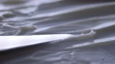 A spatula spreads a smooth Stock Footage 301310033