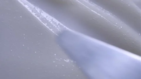 A spatula spreads a smooth Stock Footage 301310055