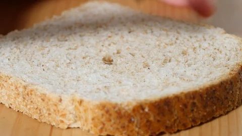 Speading chocolate on bread Stock Footage 100304626