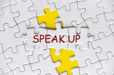 Speak Up text on missing jigsaw puzzle representing business culture in Stock Photos