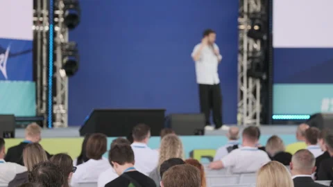 Speaker addressing audience during professional conference in modern event venue Stock Footage 313046588