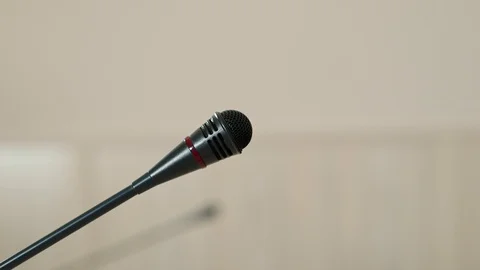 Speaker checks the microphone before speaking and speak, face close-up, side Video stock 101794277